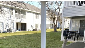 A porch with a white metal chair and a rug. - Great First Floor Condo! (Greenville)
