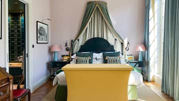 A bedroom with a bed, bedside tables, a chair, a desk, and a wardrobe.
