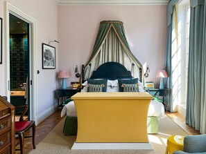 A bedroom with a bed, bedside tables, a chair, a desk, and a wardrobe. - Beaverbrook Town House (London)