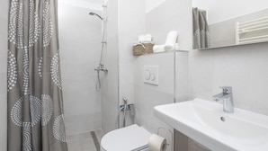 A modern bathroom with a shower, toilet, and sink. - Centrally-located two-bedroom apartment w/sunny terrace Marina IV. (Split)