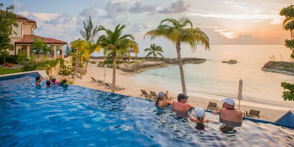 A swimming pool with a view of the beach and ocean.