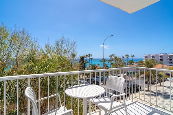 Enjoy breathtaking ocean views from this balcony, featuring a comfortable seating area with a table.