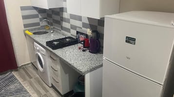 Deluxe Condo | Private kitchen | Full-size fridge, oven, stovetop, griddle