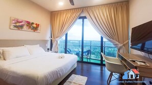 A bedroom with a bed, a desk, a chair, a ceiling fan, and a window with curtains. - Almas Suites Puteri Harbour (Iskandar Puteri)