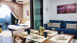 A modern hotel room with a balcony, a dining area, and a living space. - Almas Suites Puteri Harbour (Iskandar Puteri)