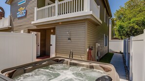 A bungalow with a hot tub, a balcony, and a sign that reads "Bow Wow Bungalow." - Pet Friendly, Recently Renovated, Private Hot Tub + Free Attraction Tickets! (North Myrtle Beach)