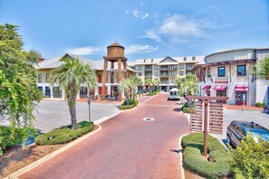 A commercial area with a central pedestrian walkway, surrounded by multi-story buildings with various businesses. - Spacious 30A Retreat Near Private Beach Access & Heated Pool (Santa Rosa Beach)