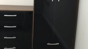 A black wardrobe with multiple drawers and two doors. - Ch & bro properties Ltd (Leeds)