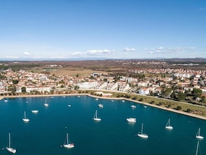 Experience the vibrant coastal town, where sailing and boating activities thrive amidst a bustling urban area.