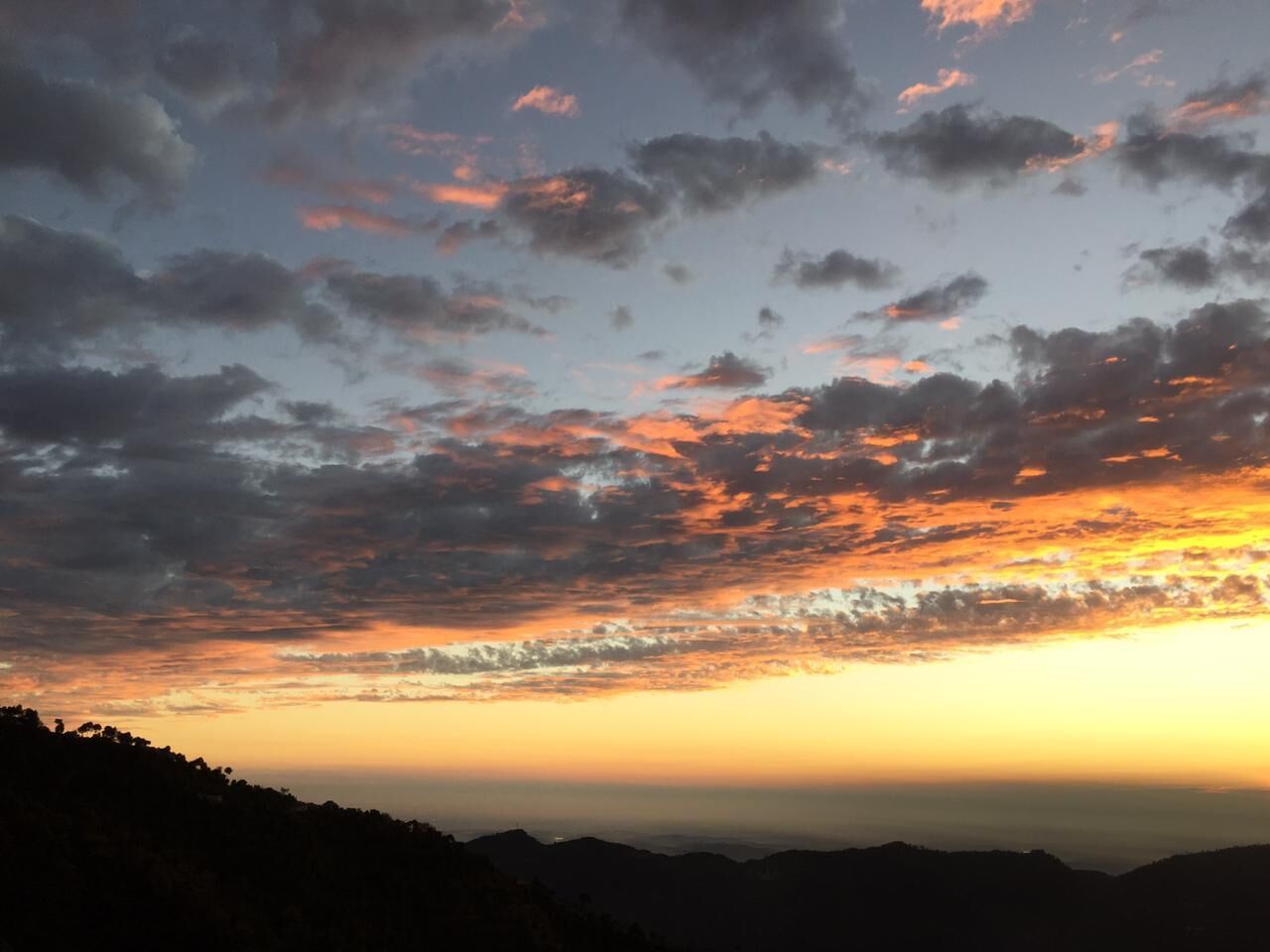 A sunset over a mountainous landscape.