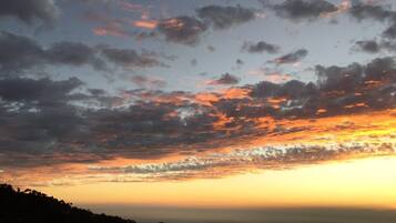 A sunset over a mountainous landscape.