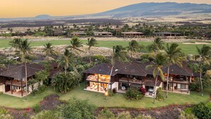 A resort with multiple villas, each featuring a private patio and a view of the surrounding landscape.