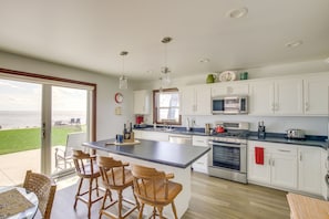 Enjoy meals and ocean views from the kitchen's spacious island with bar stools and stainless steel appliances.