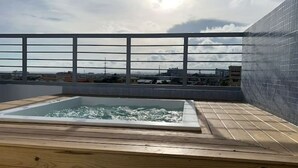 A rooftop swimming pool with a wooden deck and a metal railing. - Cómodo Apartamento en Santo Domingo Este (Santo Domingo Este)
