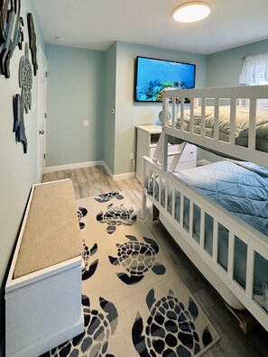 A child's bedroom with a bunk bed, a desk, and a television on the wall. - Newly Renovated 3BD/2BTH, 1 BLK to Beach (Brigantine)