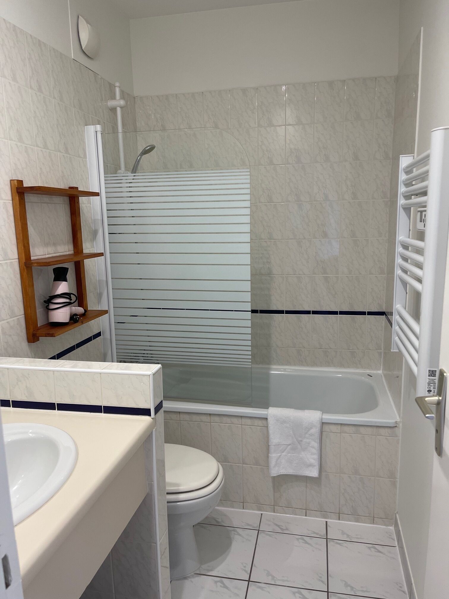 A modern bathroom with a glass-enclosed shower, a toilet, and a vanity with a sink.