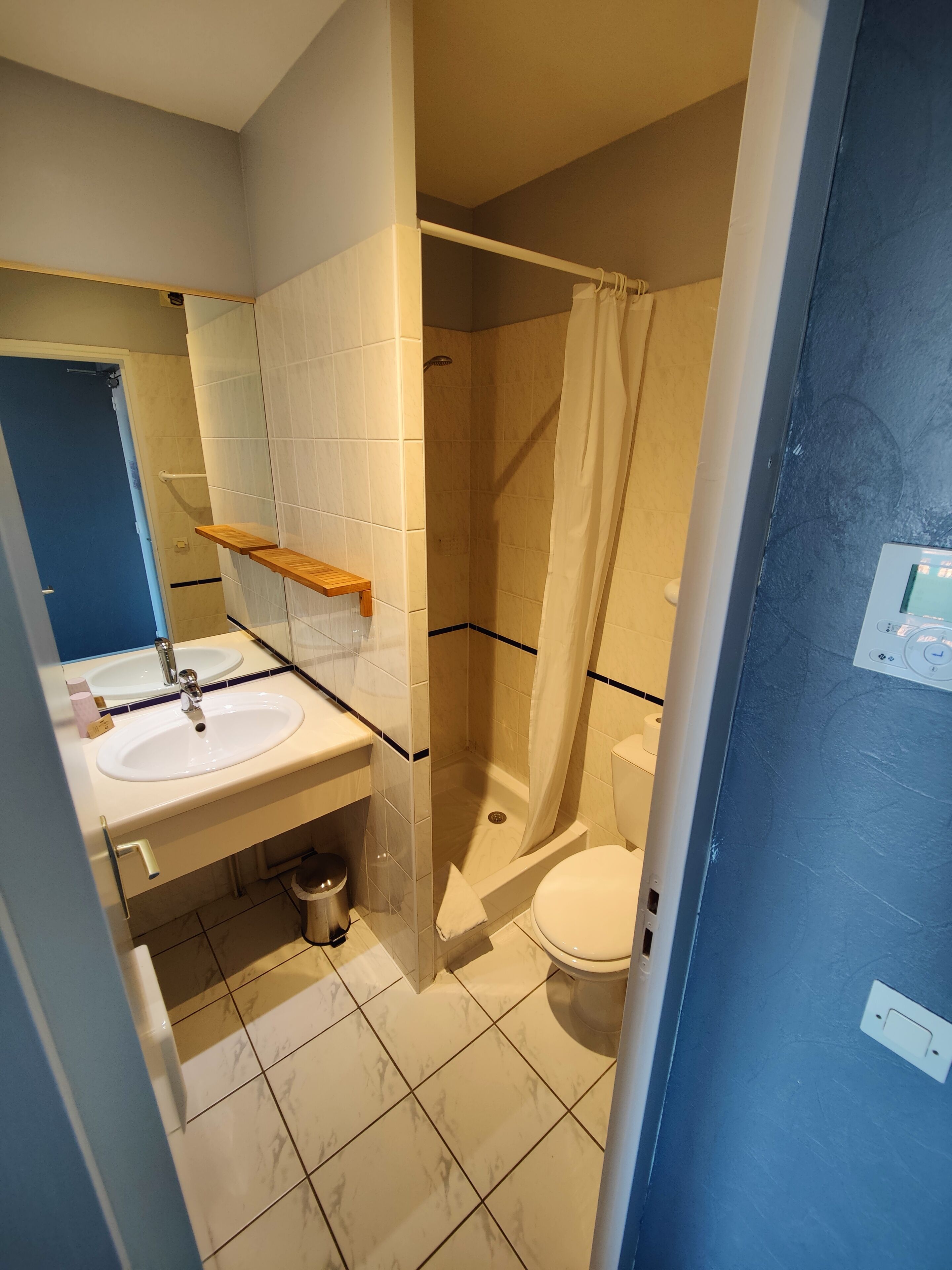 A bathroom with a shower, toilet, and sink.