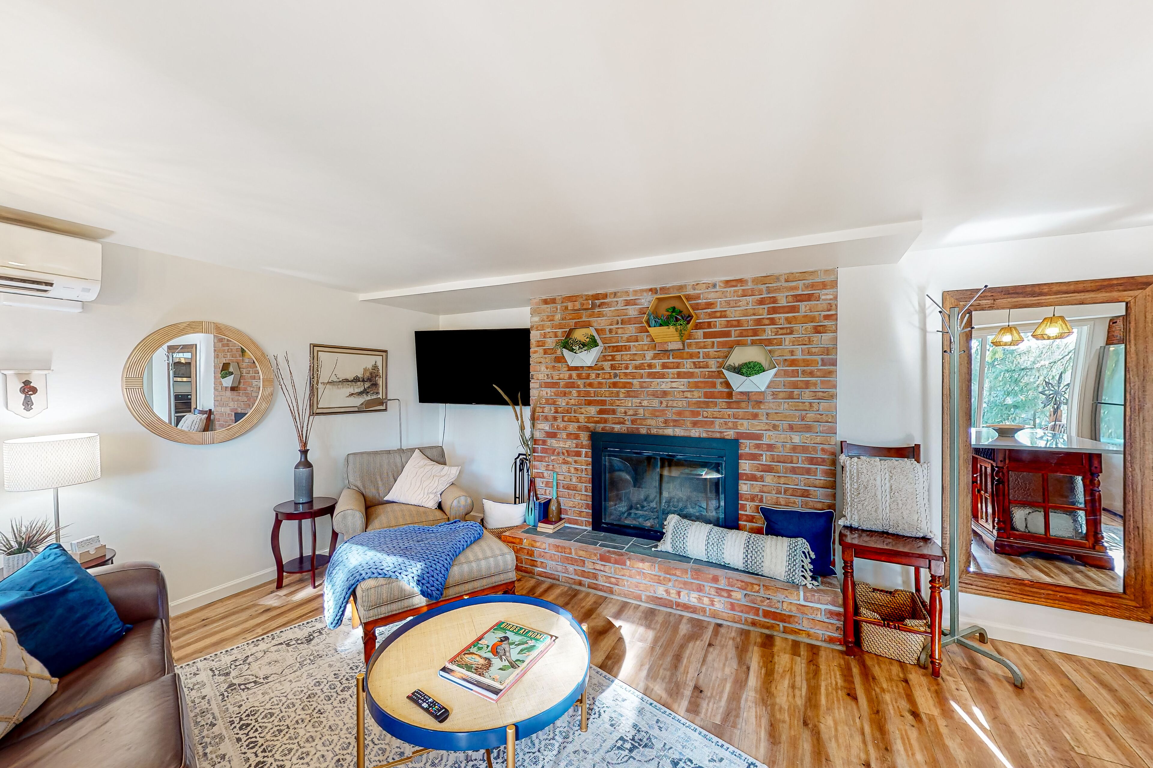 Water view apartment home with fireplace, firepit, kitchen, patio, & gas grill