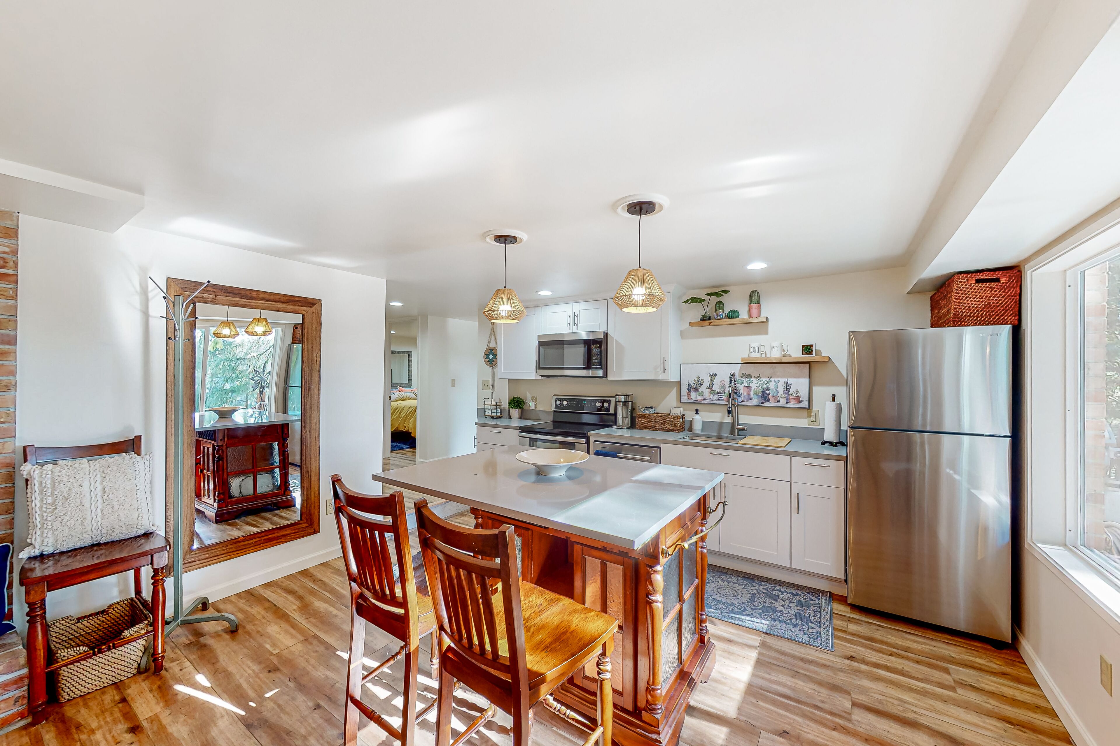 Water view apartment home with fireplace, firepit, kitchen, patio, & gas grill