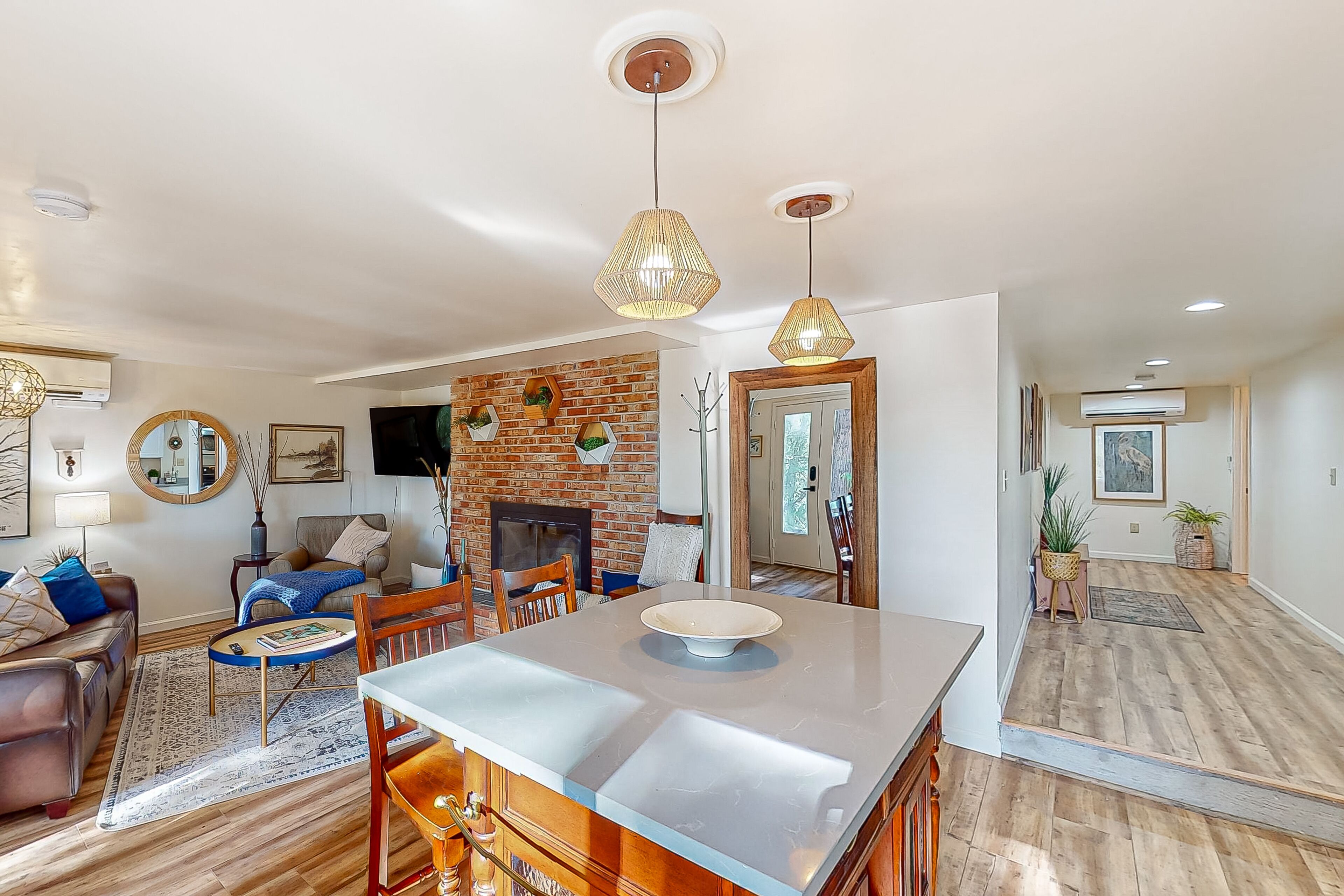 Water view apartment home with fireplace, firepit, kitchen, patio, & gas grill