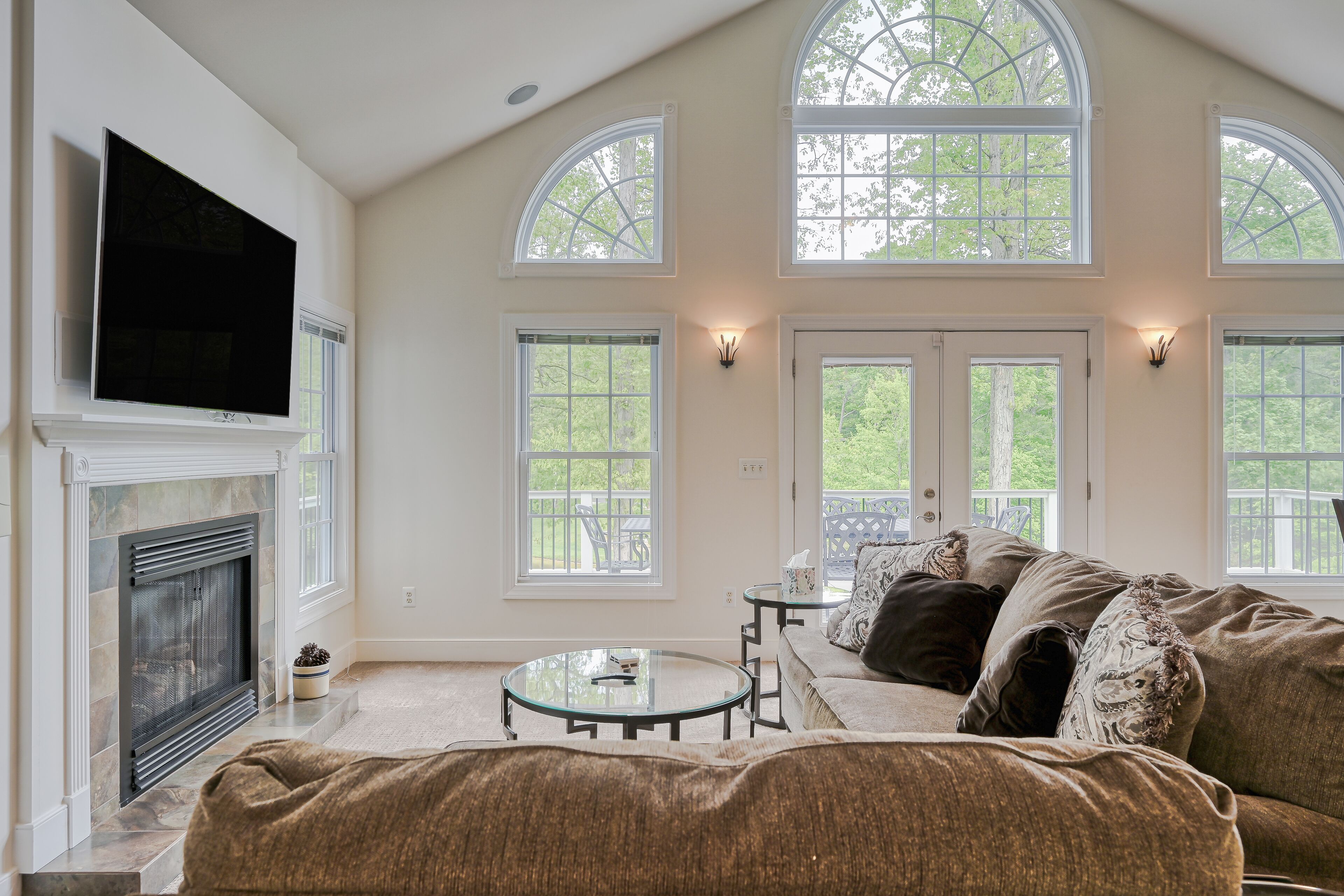 Sprawling waterfront home with a boat launch, kayaks, game room, and hot tub