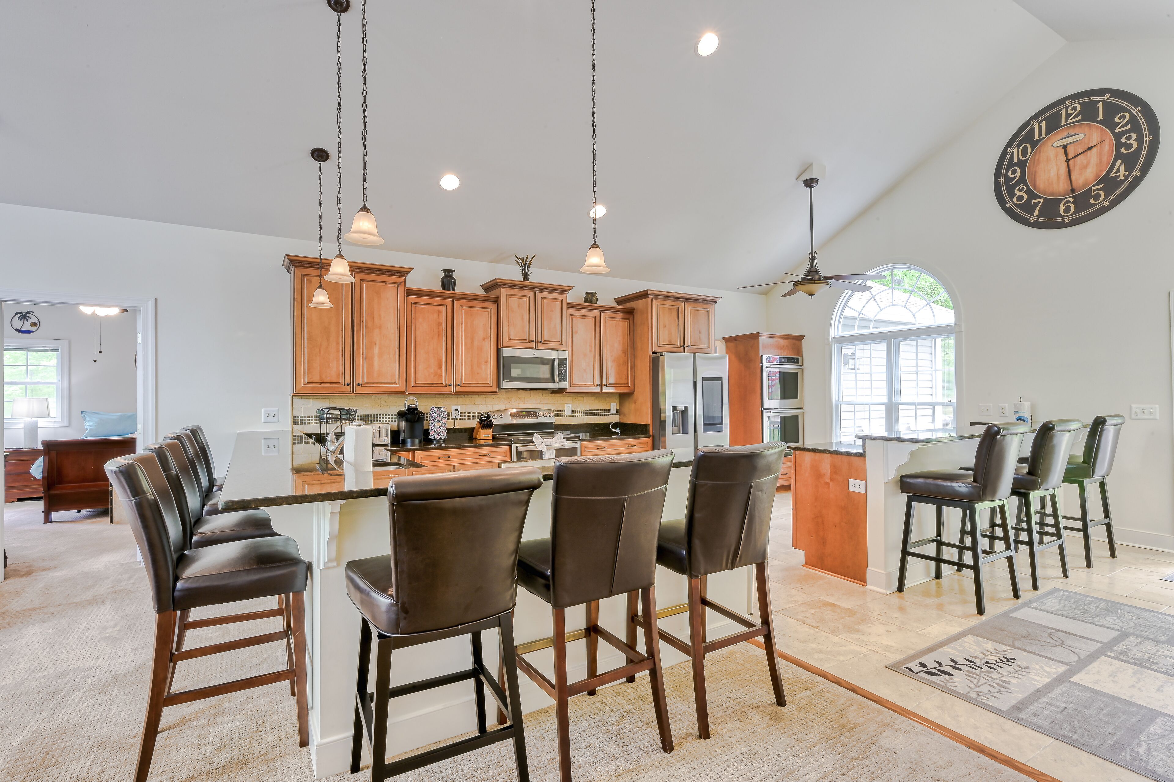 Sprawling waterfront home with a boat launch, kayaks, game room, and hot tub