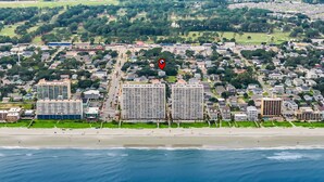 An aerial view of a coastal city with a beachfront, high-rise buildings, and a dense residential area. - Antigua Blue - Private Pool - Walk to Beach - 6BR/7BA (North Myrtle Beach)