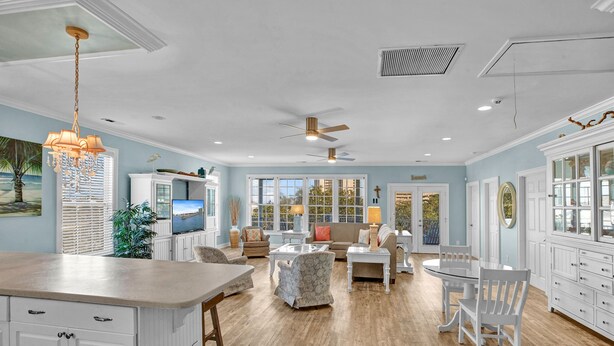 A spacious living area with a large island, a sofa set, and a dining table. - Antigua Blue - Private Pool - Walk to Beach - 6BR/7BA (North Myrtle Beach)