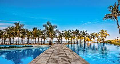 Luxury ocean-view condo with resort pool, private balcony, and washer/dryer