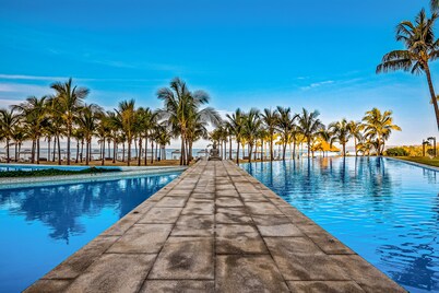 Luxury ocean-view condo with resort pool, private balcony, and washer/dryer