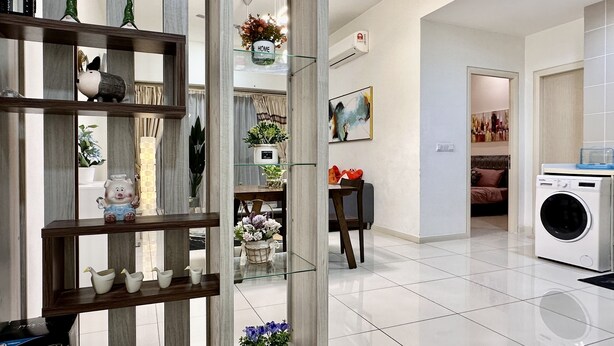 A modern living room with a glass partition, a dining area, and a laundry room. - Homey Family Gateway (Petaling Jaya)