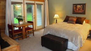 A bedroom with a bed, a desk with chairs, a lamp, and a painting on the wall. - Seven Springs 3 BR Condo, walk to slopes! by RedAwning (Champion)