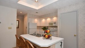 A compact kitchen with a white countertop, a sink, and a fruit basket. - Seven Springs 3 BR Condo, Loft and Mountain Views! by RedAwning (Champion)