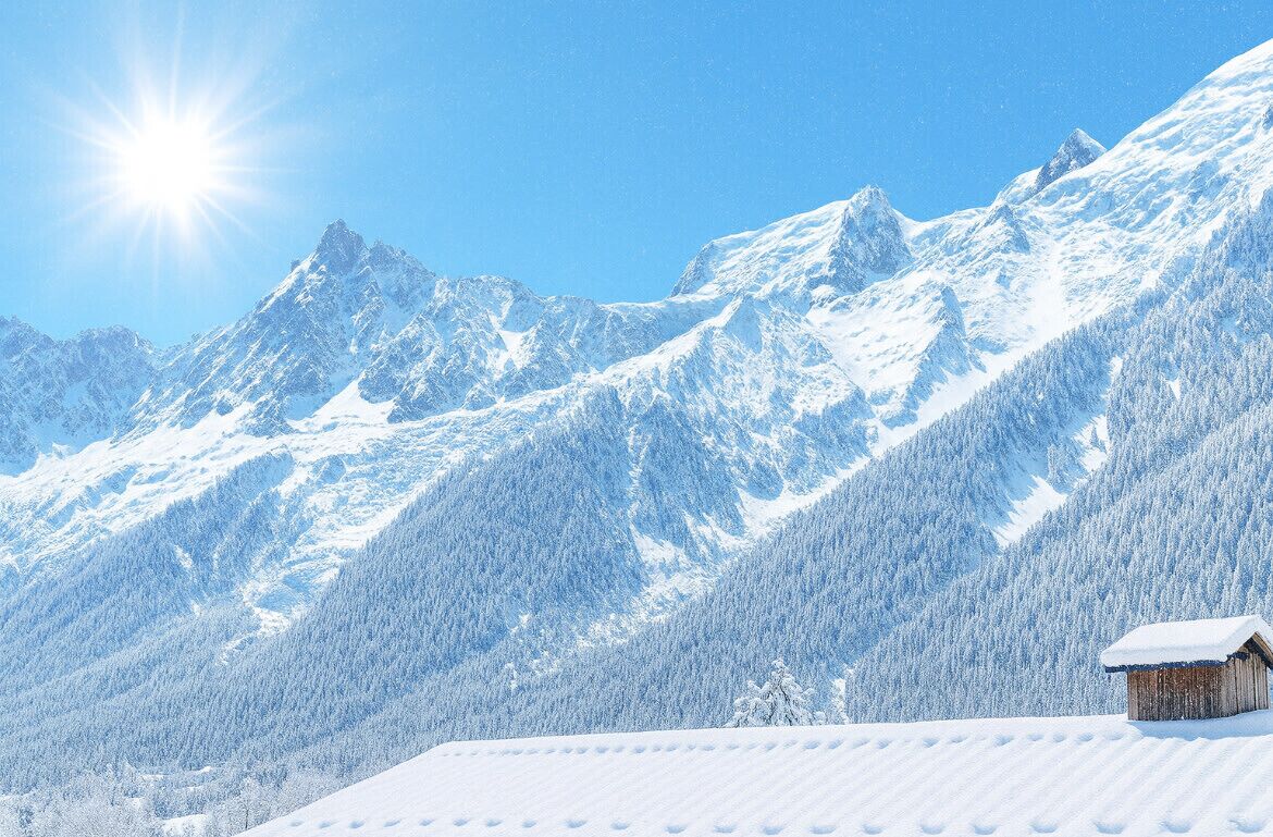 A snow-covered mountain landscape with a wooden cabin.