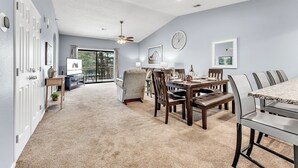 A spacious living room with a large dining table, comfortable seating, and a view to the outside. - Gorgeous, Pools, Hot Tub, Golf, 3 Min To Strip! (Branson)