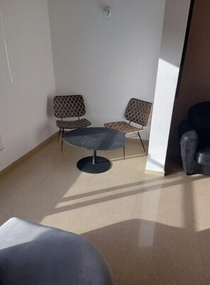 Sit comfortably in this cozy space with a round table and two chairs.