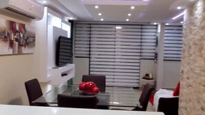 A modern conference room with a glass table, black chairs, and a red decorative item. - Aquatika Happy Place *pools and beach access* (Medianía Alta)