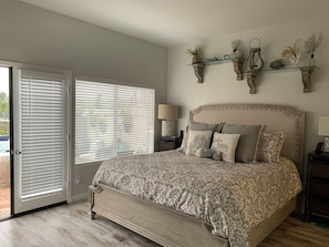 A bedroom with a bed, a nightstand, a lamp, and a window with blinds. - Summer Special at Monarch Beach, Dana Point (Dana Point)