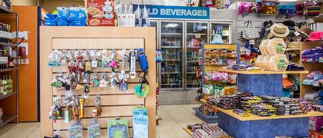 A store with a 'Cold Beverages' section, a variety of keychains, and a display of snacks and candies.