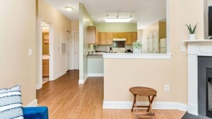 A modern kitchen with wooden cabinets, a central island, and a built-in stove.