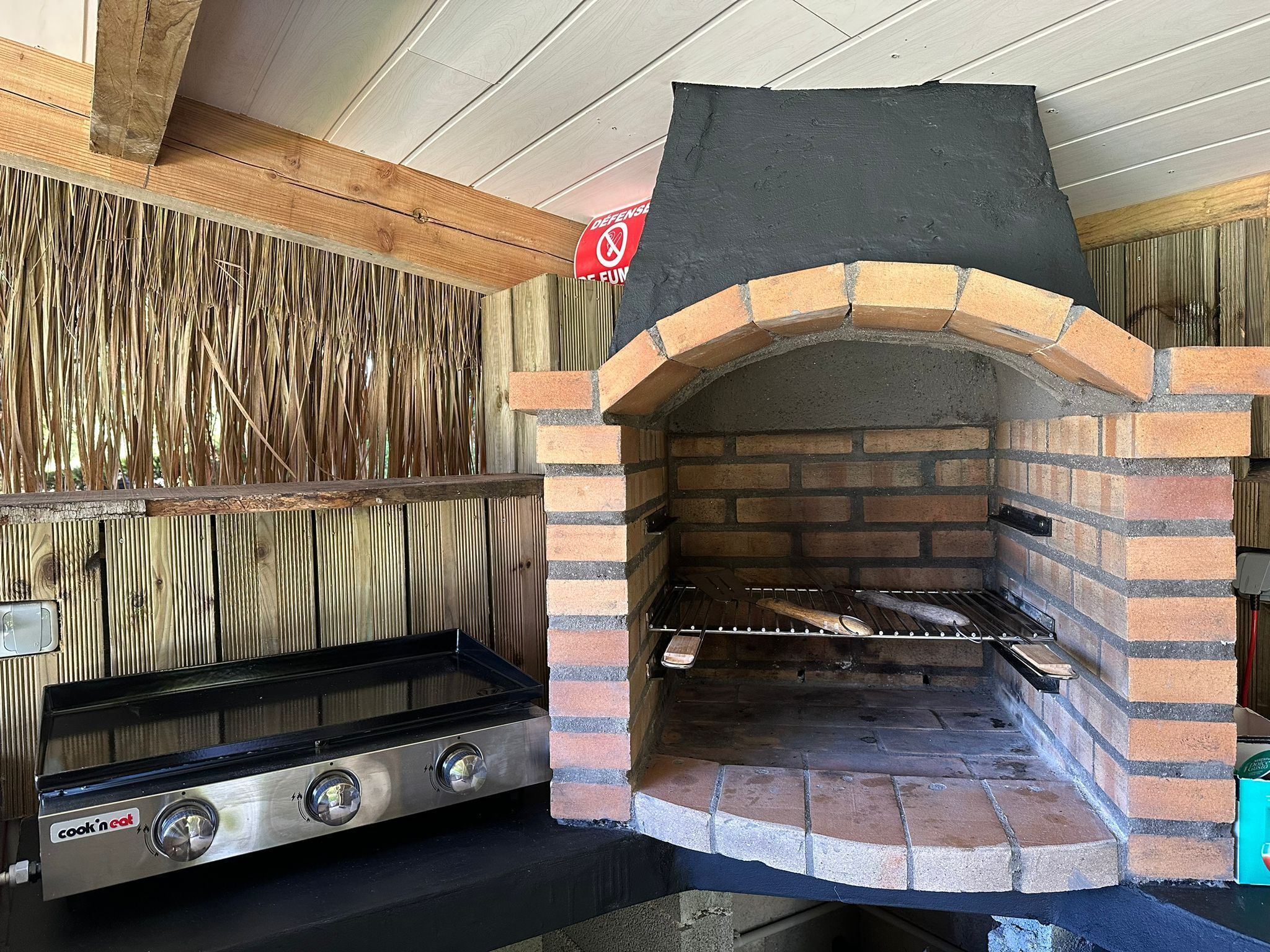 A brick oven with a grill and a cook'n'cat stove.