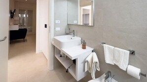 A modern bathroom with two sinks, a large mirror, and a towel rack. - Maruzza Home 201 (Favignana)