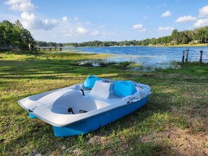 Guests can enjoy a boat on the water's edge, near a dock and bridge.