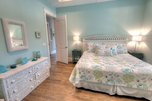 A bedroom with a bed, dresser, and nightstands, featuring a nautical-themed bedspread and decor. - Canal-Front Oasis with Private Dock, Pool, Near Beach and Shops - Aqua Cove (Anna Maria)