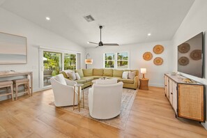 Relax in a spacious living area with a sofa, armchair, and flat-screen TV.