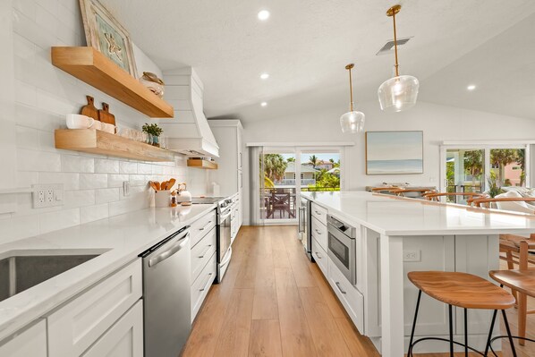 Enjoy cooking in this kitchen with a central island, bar stools, and ample counter space.