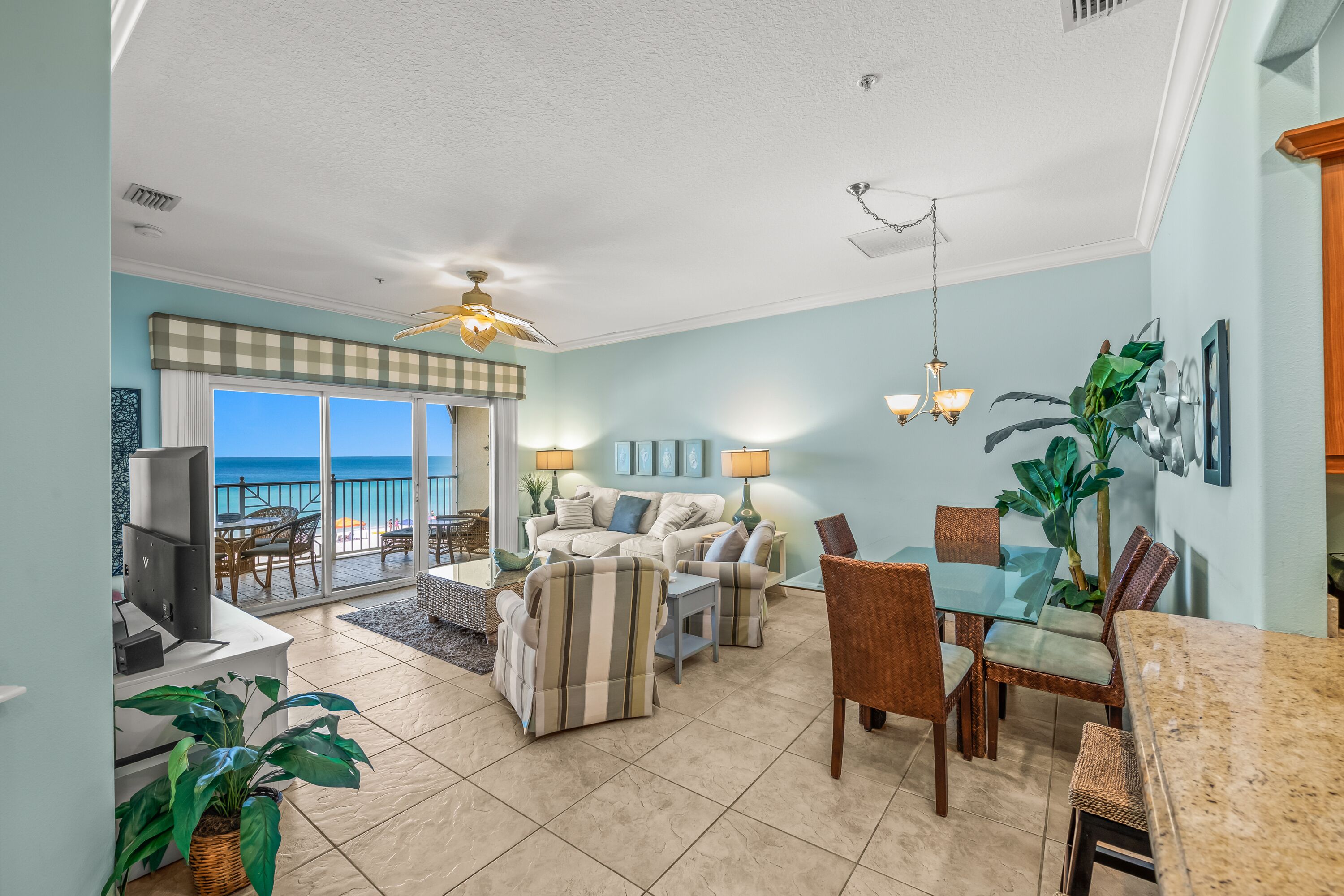 A spacious living room with a balcony, a dining area, and a kitchen.