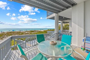 Relax in this serene beachside retreat with a balcony and comfortable seating area.