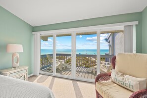 Enjoy the beach view from your balcony through the large sliding glass door.