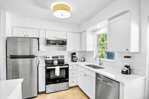 Enjoy cooking in this well-equipped kitchen with a refrigerator, microwave, stove, oven, and dishwasher.